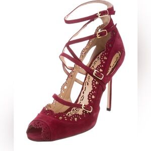 Purple suede Marchesa Marina pumps w/ laser-cut motif.